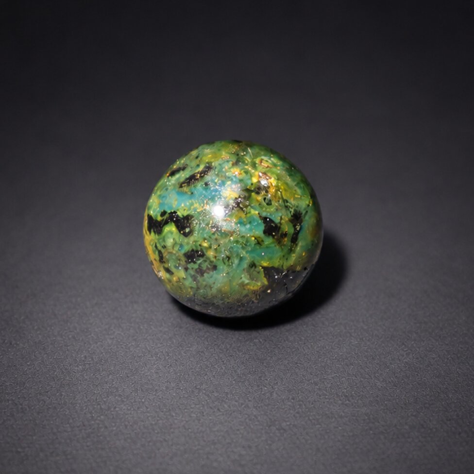 Untreated olive green blue Dominican amber sphere/ball 20mm